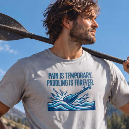 Man with a kayak paddle over his shoulder wearing the Pain Is The Program STRIKE Vector tee in Sport Grey — "Pain is temporary. Paddling is forever." paddle-splash design — Vector Paddle