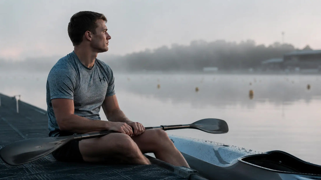 Competitive kayaker focusing at the start line, illustrating the mental preparation required for sprint racing