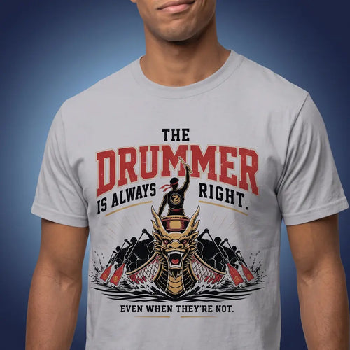 A man wearing a light gray crew-neck t-shirt with a graphic print that reads 'THE DRUMMER IS ALWAYS RIGHT.' in red and black, featuring a stylized dragon boat illustration.